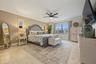 Expansive Waterfront Primary Bedroom with Sliding Glass Door to the Balcony