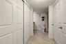 Primary bedroom walk-in closets - leading into the Bathroom