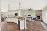Large kitchen with pantry is open to living area.