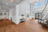Wood-finish flooring throughout, with wainscoting and crown molding details