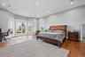 Hardwood flooring, recessed lighting, crown molding, bay window, and light gray wall paint