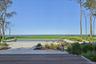 Expansive exterior with a rectangular swimming pool, surrounding paver patio, and wood-finish decking