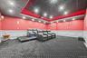 Dedicated media room featuring patterned wall-to-wall carpeting, wainscoting, and recessed lighting