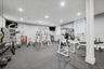Dedicated fitness room featuring recessed lighting, a drop ceiling, and durable rubber flooring