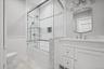 White vanity with a single basin sink and polished chrome faucet