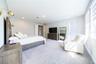 Spacious primary bedroom with a sitting area, double-door entry, and direct porch access.