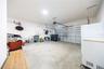 Spacious two-car garage with an automatic door opener and room for additional storage.