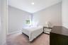Comfortable bedroom with soft carpeting and a soothing neutral palette.