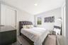 Inviting bedroom with soft carpeting, neutral tones, and a double-door closet.
