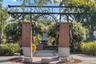 Centennial Plaza in Winter Garden, featuring a decorative archway, flowering vines, and a fountain.