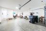 Spacious garage with direct home access and additional room for storage or a workshop.