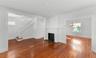 spacious living room to dining room with fireplace. Side hall style