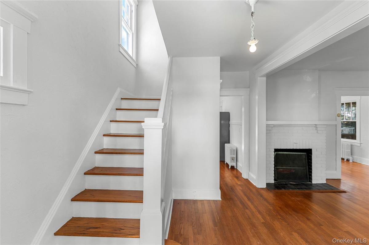 side hall colonial, fireplace, hardwood floors original details