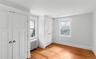 1 of 3 bedrooms with two closets and hardwood floors