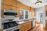 kitchen with granite counters, leads to back entry area