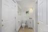 Main level powder room leading to the Laundry Room