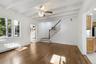 Living room with Chandelier Fan and Stair Case Leading to 2nd Floor