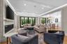 Den with gas fireplace, open concept with view into the kitchen, breakfast room, and backyard