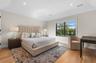 Hardwood flooring, recessed lighting, and a window with dark framing