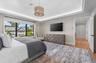 Recessed lighting, crown molding, wood-finish flooring, and a large window