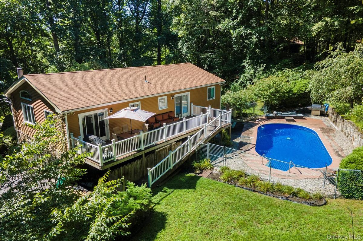 Back deck off the kitchen and walk down to a deck and inground pool.