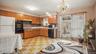 Kitchen featuring wood-finish cabinetry, tile flooring, built-in oven, and a sliding glass door