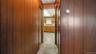 Wood paneling and carpeted flooring in hallway