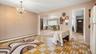 Recessed mirror wall paneling, crystal chandelier, and patterned floor tile
