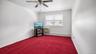 Recessed red carpeting and a multi-speed ceiling fan