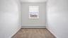 Recessed window with a white frame, neutral carpet, and white walls