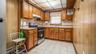 Kitchen featuring wood cabinetry, stainless steel range, and tile flooring
