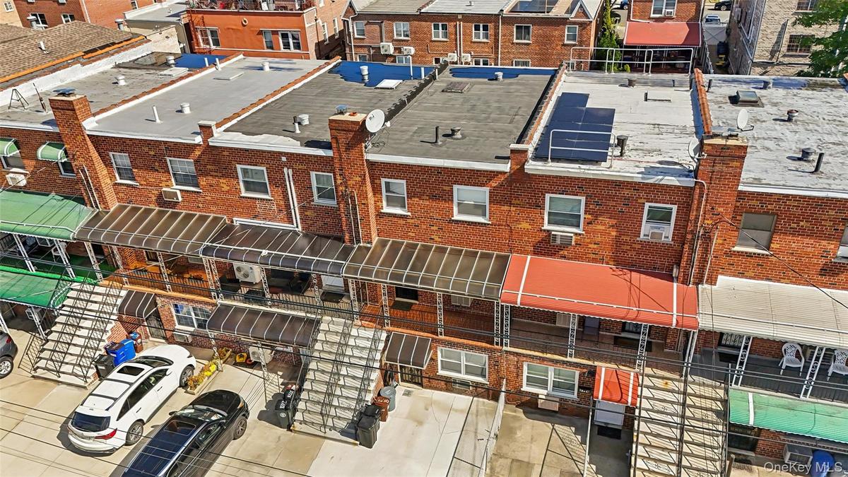 Red brick exterior with multiple windows and flat roofs
