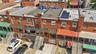 Red brick exterior with multiple windows and flat roofs