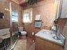 Nicely tiled full bathroom off living room
