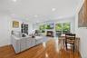 Living Room with wood burning Fireplace and sliding glass door to wood deck