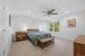 Primary Bedroom Suite with recessed lights, ceiling fan, huge walk-in closet with attic scuttle access