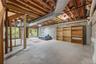 Huge Unfinished storage space with sliding glass door to stone patio