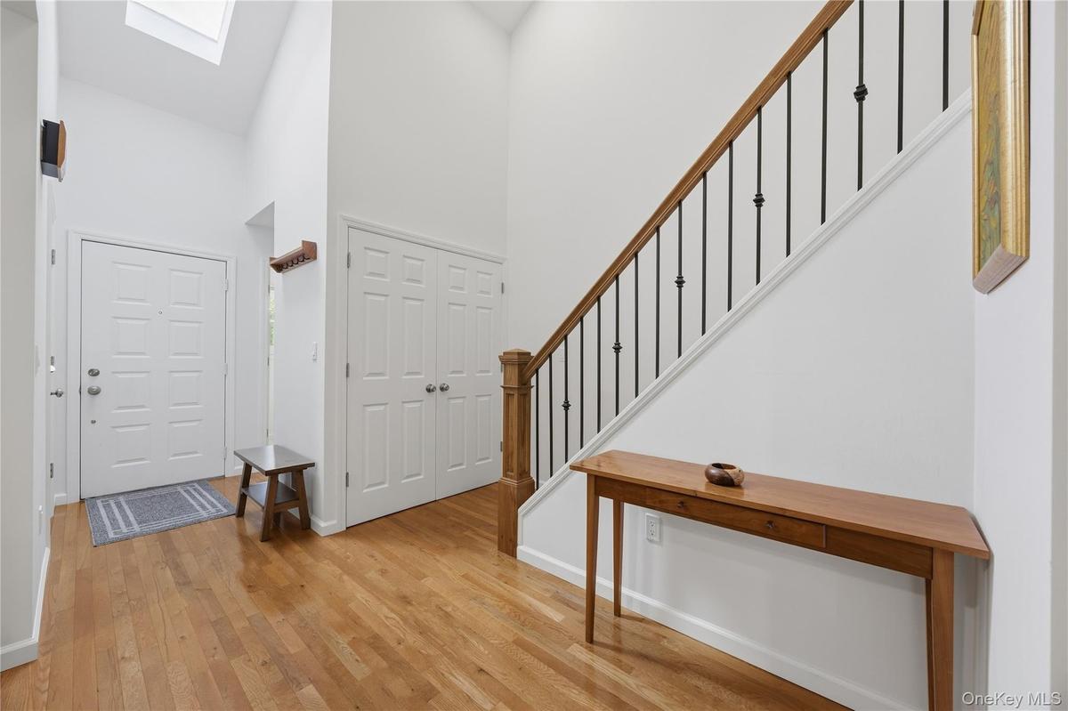 Bright Entry Foyer with coat closet and skylight