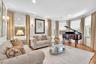 Recessed lighting, crown molding, wood-finish flooring, multiple windows, and wall sconces