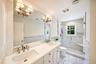 Dual vanity with integrated sinks and brushed brass fixtures