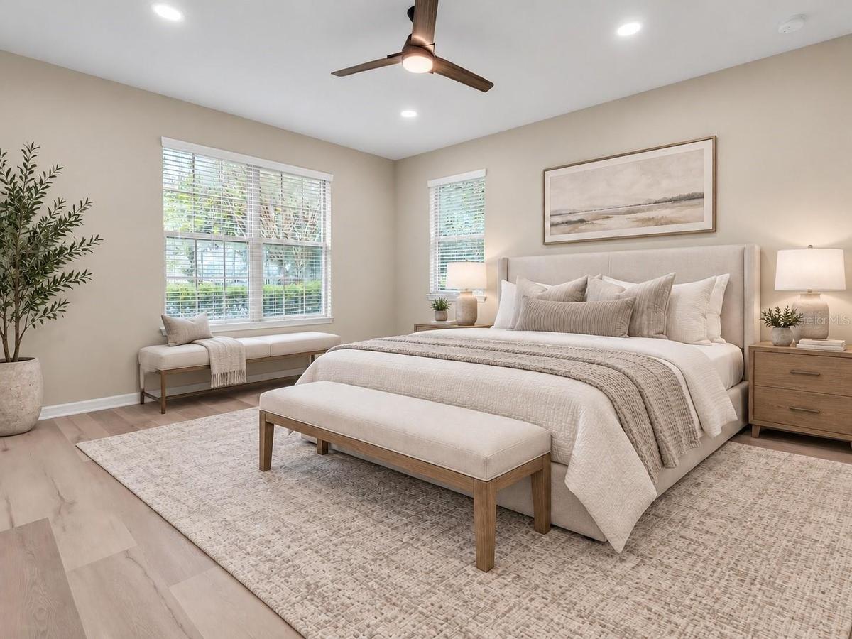 Bedroom with ceiling fan and natural light