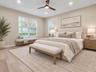 Bedroom with ceiling fan and natural light