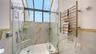 THE TOWEL WARMER W/ THE GARDEN WINDOW IN THE PRIMARY BATHROOM