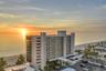 As the sun slips behind the skyline, the Gulf glows in its final golden bow