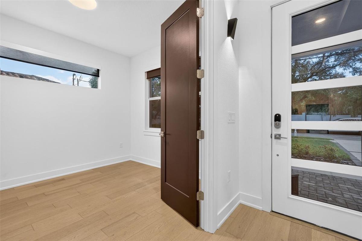 Foyer and large office-den-5th bedroom-double wood doors.