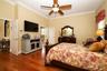 Owners suite with large walk-in closet that has custom built-ins