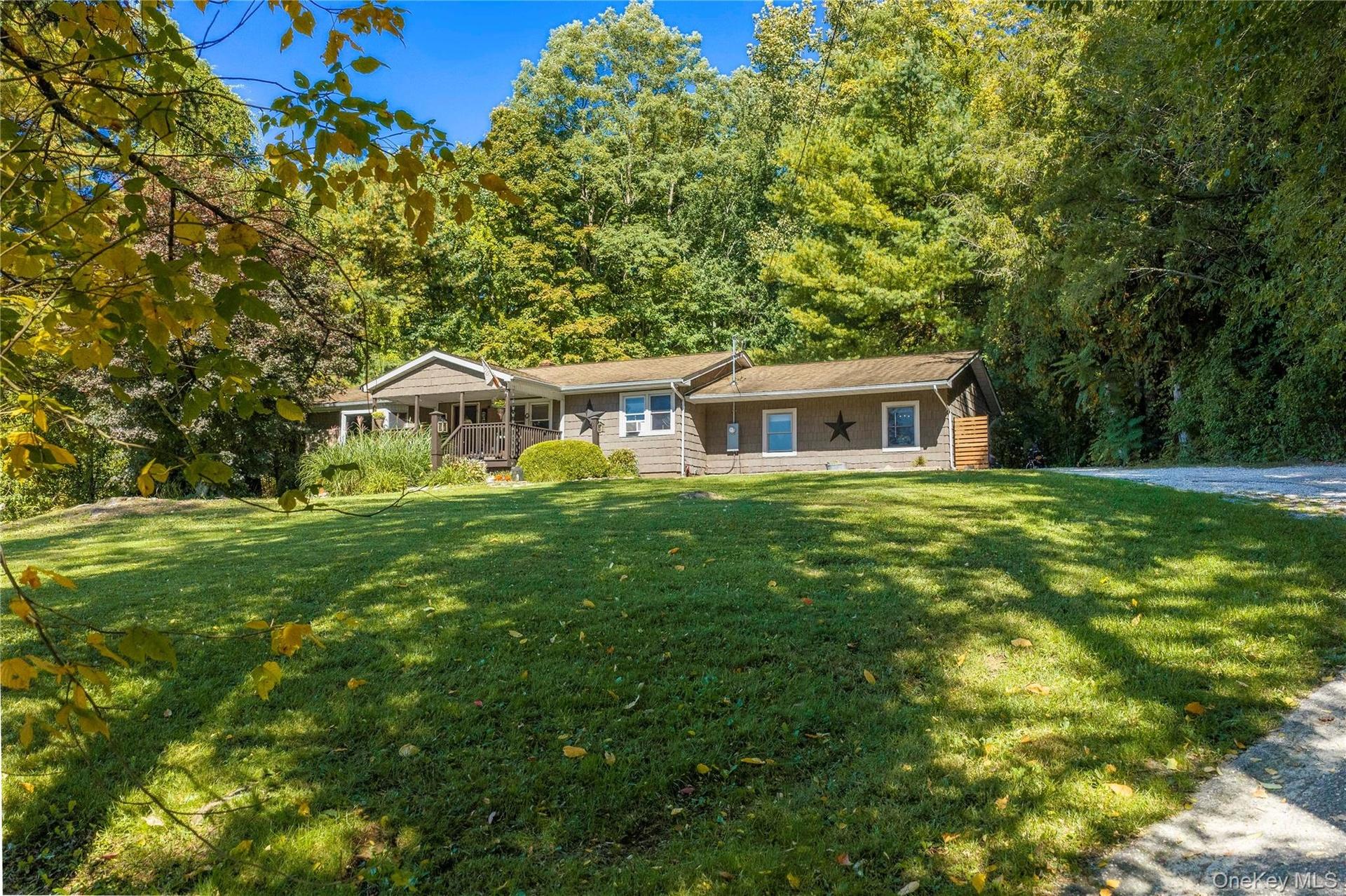Convenient one-level living meets timeless country charm in this delightful ranch-style home, set high atop almost an acre and perfectly positioned fo