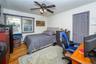 The main floor boasts five versatile bedrooms. The current setup utilizes three as dedicated bedrooms. View of one of the bedrooms.