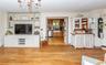 A wide opening from the living room flows naturally into the country kitchen.
