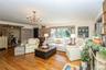 A large bay window,  and a rustic sliding barn door leading to the adjacent dining room.